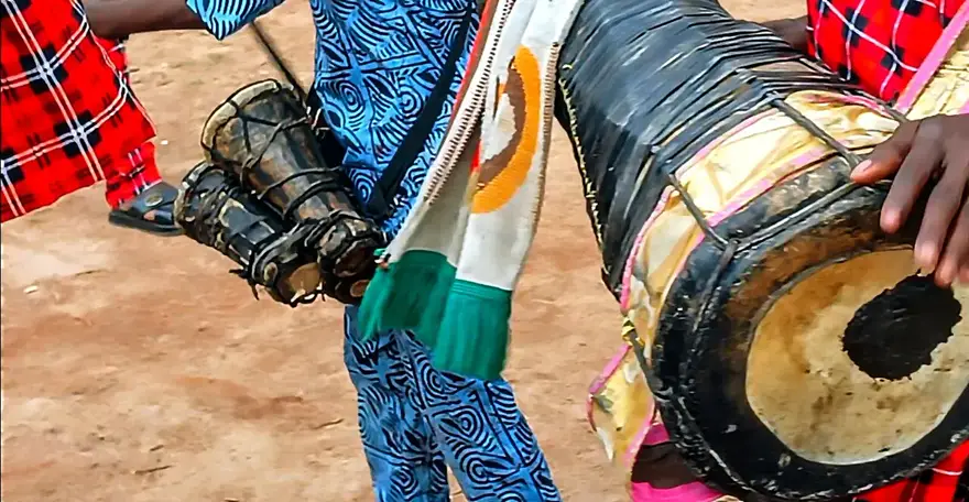Hands playing a batá drum