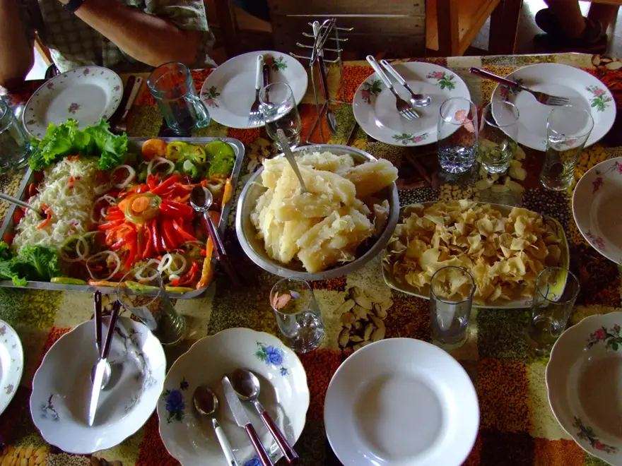 A Cuban creole table laid with the classics — yuca, salads and tostones, the food you learn to cook