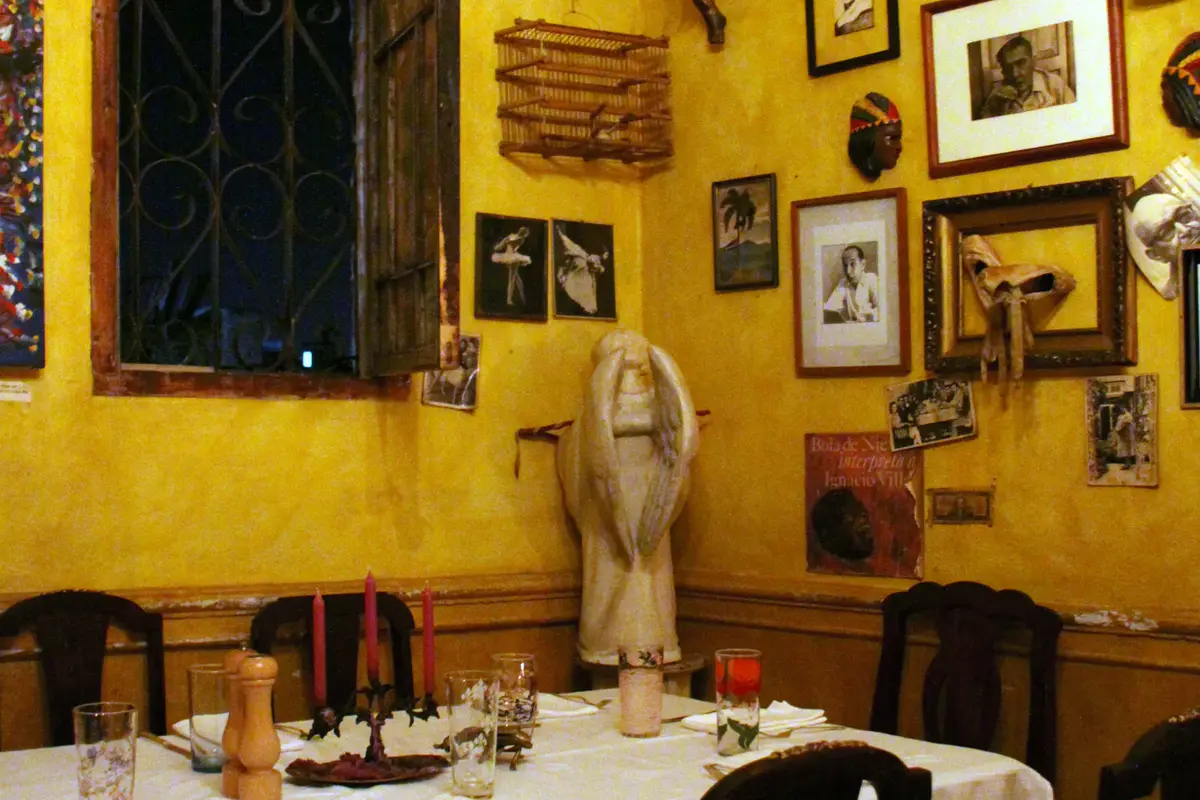 The dining room of La Guarida, a family paladar inside a Havana mansion — the kind of table the Concierge books for you